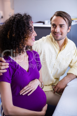 Man comforting his pregnant woman in ward