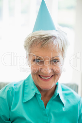 Smiling senior woman with party hat