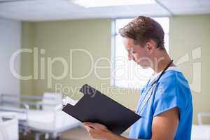 Doctor writing on clipboard