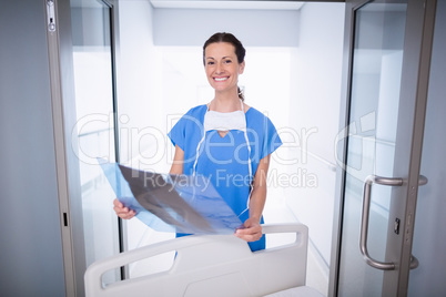 Portrait of doctor standing with x-ray report