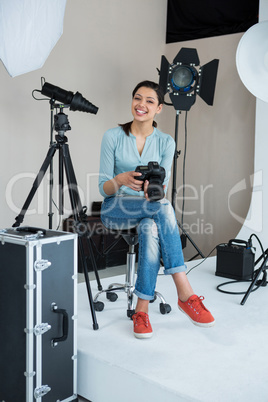 Happy female photographer in studio