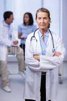 Portrait of female doctor standing with arms crossed