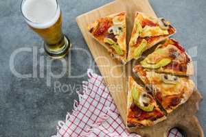 Pieces of italian pizza served with glass of beer