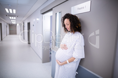 Pregnant woman standing in corridor