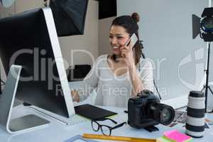 Female photographer talking on mobile phone