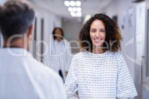 Portrait of pregnant woman standing in corridor