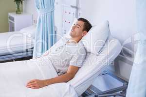 Male patient sleeping on bed