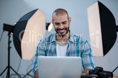 Photographer working over laptop