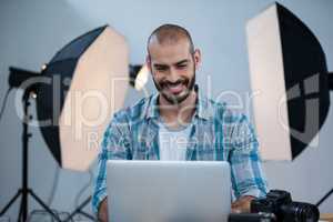 Photographer working over laptop
