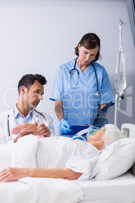 Doctors examining patients pulse