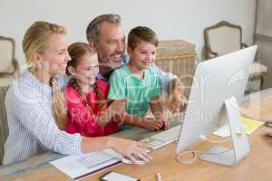 Family using computer at home