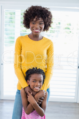 Portrait of mother embracing her daughter