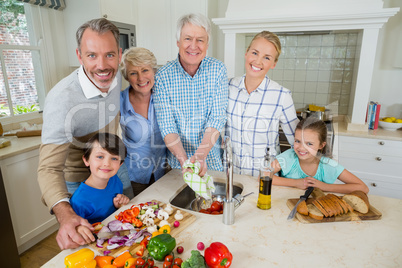 Happy family preparing food in kitchen