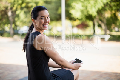 Happy businesswoman holding mobile phone