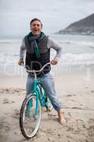 Portrait of mature man riding bicycle on the beach