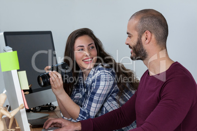 Photographer working at his desk with colleague