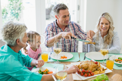 Multi- generation family having meal on dinning table