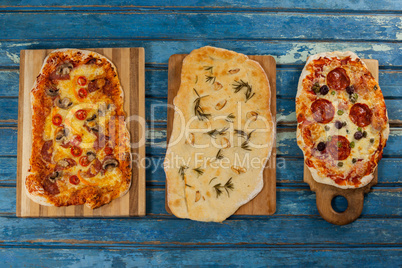 Various delicious italian pizza served on wooden plank