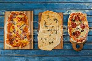 Various delicious italian pizza served on wooden plank