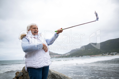 Senior woman taking a selfie from selfie stick