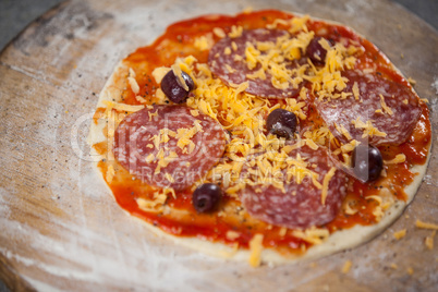 Pizza dough with tomato sauce with grated cheese