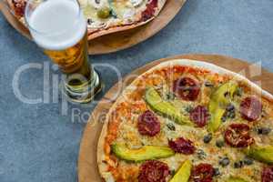 Italian pizza served with a glass of beer
