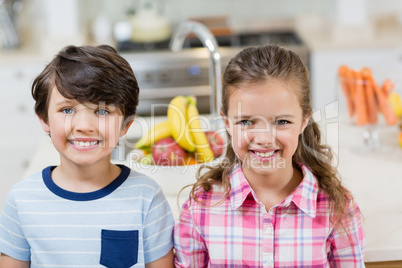 Portrait of sibling smiling in kitchen