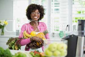 Beautiful woman holding fruits at home