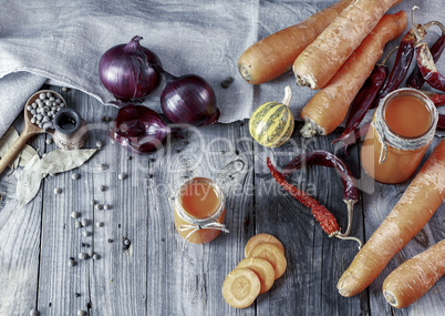 Fresh homemade carrot juice in glass jars