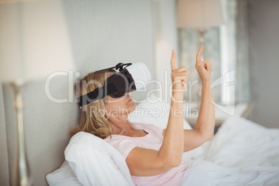 Senior woman using virtual reality headset