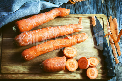 fresh long carrot on a chopping board