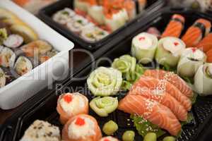 Assorted sushi set served in plastic boxes