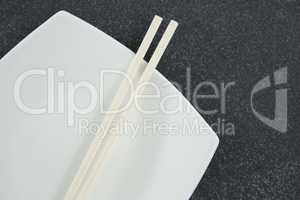 Chopsticks on white plate