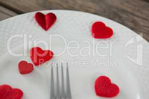 White plate with red hearts and knife