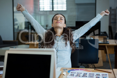 Graphic designer stretching her arms out