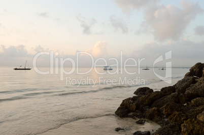 Several dhow on the ocean at sunrise