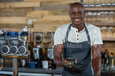 Waiter holding a credit card reader