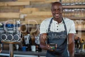 Waiter holding a credit card reader