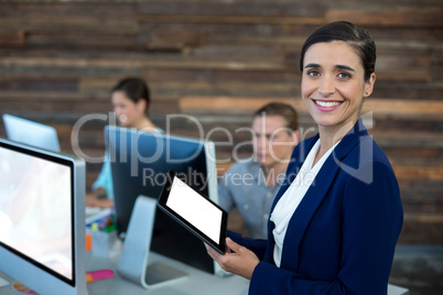 Portrait of smiling businesswoman using digital tablet