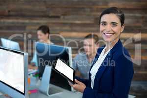 Portrait of smiling businesswoman using digital tablet