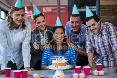 Portrait of businesspeople celebrating their colleagues birthday