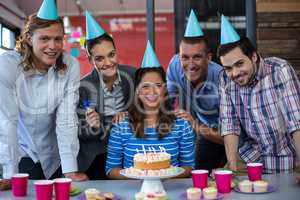 Portrait of businesspeople celebrating their colleagues birthday