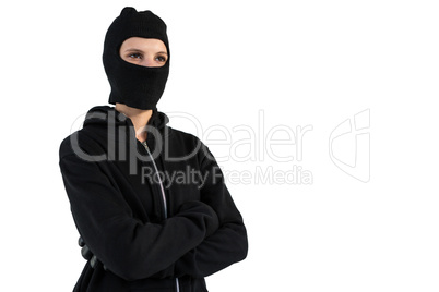 Thoughtful female hacker standing with arms crossed