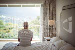 Senior man looking at the view through the window