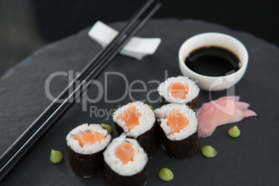Sushi on tray with soy sauce and chopsticks