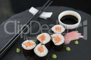 Sushi on tray with soy sauce and chopsticks