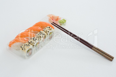 Plate of nigiri and uramaki sushi with chopstick