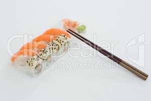 Plate of nigiri and uramaki sushi with chopstick