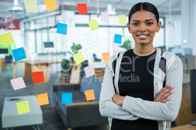 Portrait of businesswoman standing with arms crossed in office