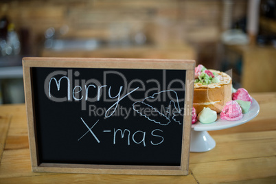 Merry x mas sign board with cake at counter